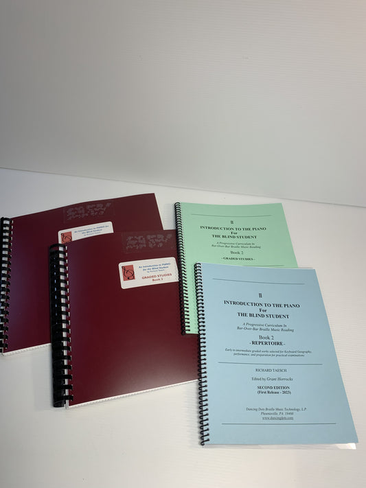 Four spiral-bound books on a white background.